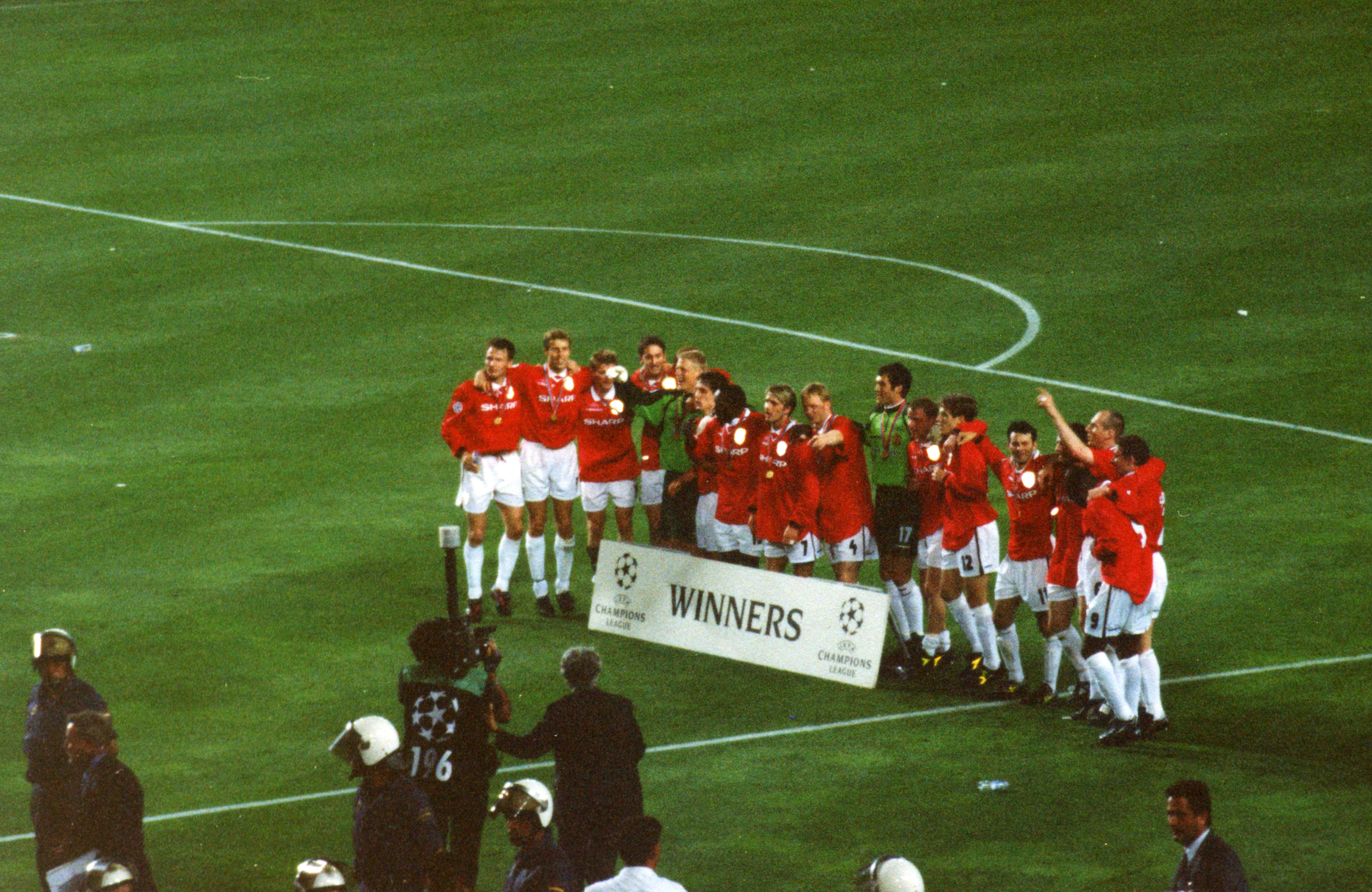 Manchester United's players celebrate winning the 1998–99 UEFA Champions League after their victory over Bayern Munich in the 1999 UEFA Champions League Final at the Camp Nou, Barcelona, on 26 May 199
