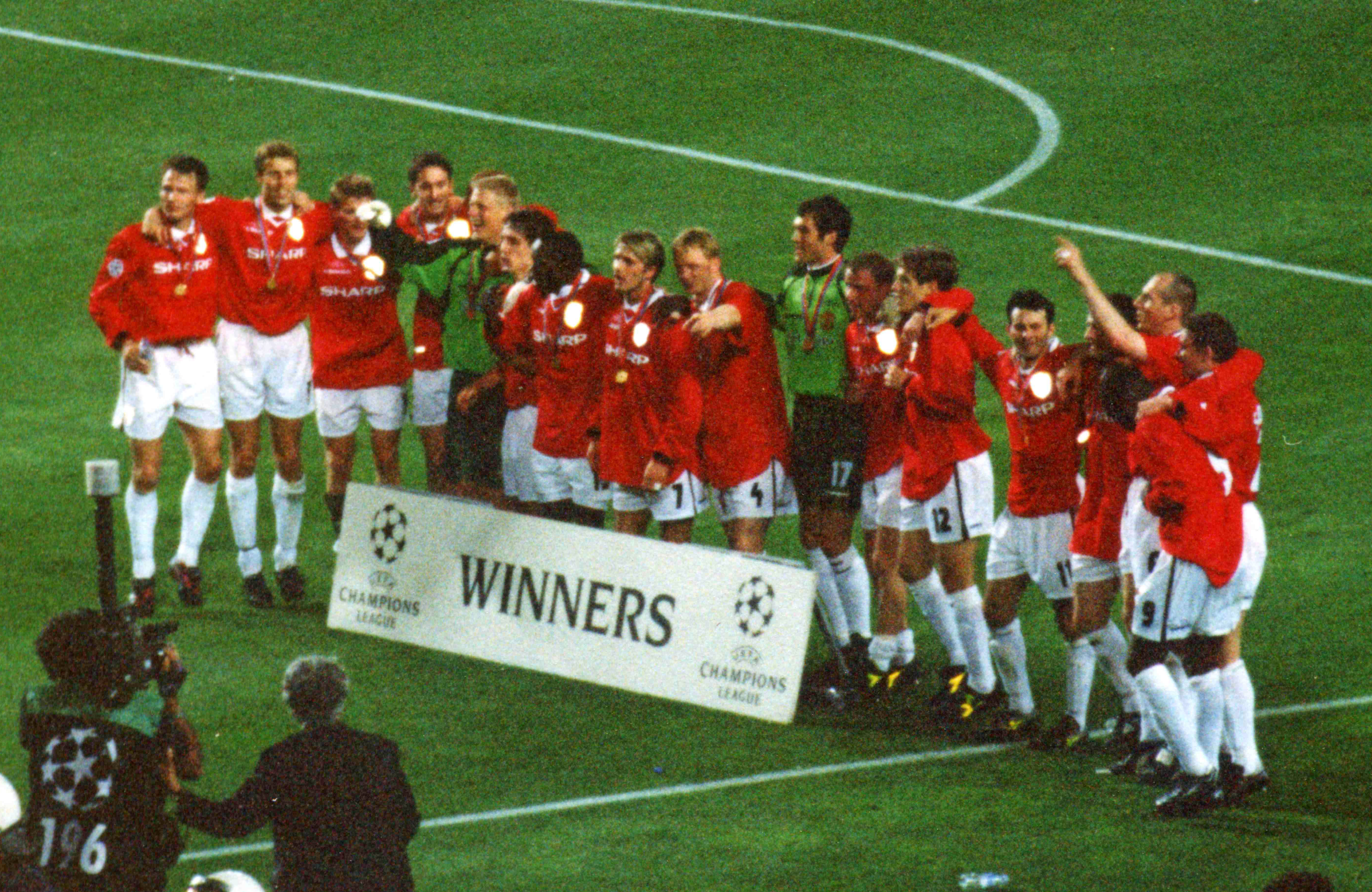 Manchester United's players celebrate winning the 1998–99 UEFA Champions League after their victory over Bayern Munich in the 1999 UEFA Champions League Final at the Camp Nou, Barcelona, on 26 May 199